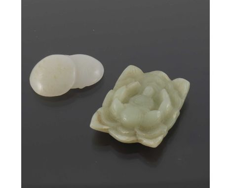 Two Chinese carved jade pendants, one modelled in relief with a Buddha in lotus flower, the other in white jade as two fruits