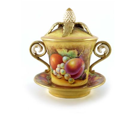 D Fuller for Royal Worcester, a fruit painted cup, cover and stand, twin handled flared form with relief moulded pineapple fi