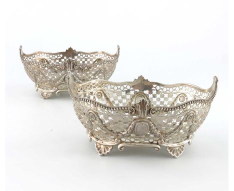 A pair a of Victorian silver reticulated baskets, Charles Stuart Harris, London 1893, serpentine edged boat form, pierced wit