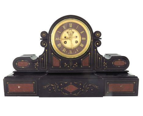 A 19th century black marble mantle clock, circa 1890, domed and bracketed, incised with gilt tooling, and set with red marble