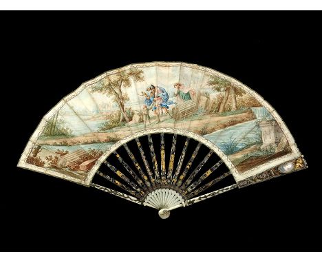 λ An 18th century articulated ivory fan, the ivory sticks and guards finely carved, pierced, silvered and gilt, each of the u