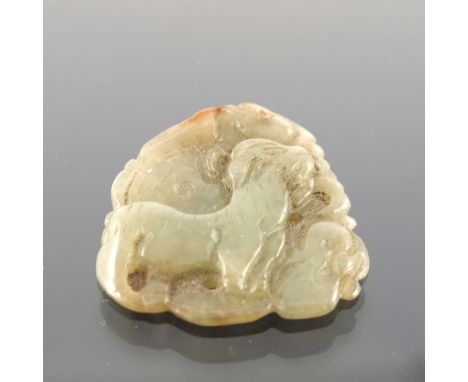 A Chinese carved jade pendant, in the form of a goat amongst foliage, the reverse with peach, 4cm