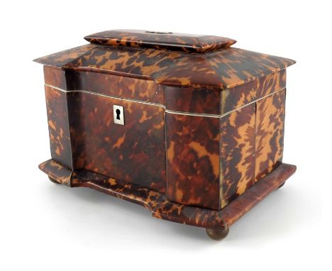 A Victorian tortoiseshell tea caddy, circa 1840, break front cuboid form with silvered stringing, opening to reveal a two com