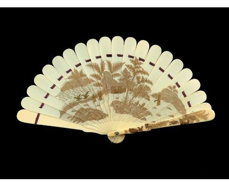 λ An unusual 19th century Japanese ivory and gilt lacquered brise fan, both sides similarly decorated in various tones of fin