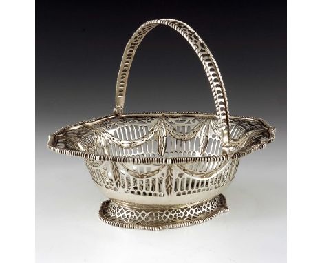 A George II silver reticulated basket, Henry Brind, London 1744, ogee rimmed oval form, footed with everted rim, embossed wit