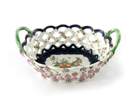 A Worcester porcelain chestnut basket, circa 1770, open lattice form with studded rosettes, painted with Chinese style floral