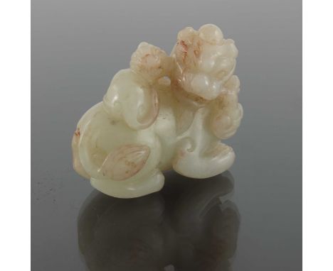 A Chinese jade carving, modelled as two lions, with a fruiting branch, 7cm 