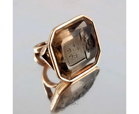 An early 19th century yellow metal and smoky quartz fob seal, intaglio engraved with the arms and crest of Astley, 2.5cm long