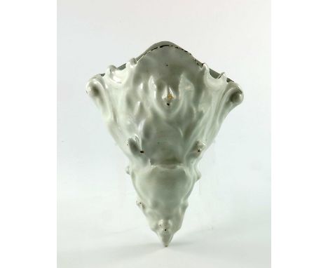 A mid 18th Century delftware wall pocket, Liverpool, moulded with masks and scrolls, pierced twice for hanging, 20cm high