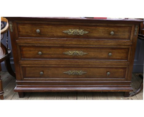An Empire style mahogany gilt metal mounted commode, circa 1900, with three long drawers, the escutcheons cast as angels with