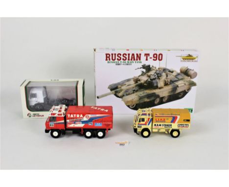 A boxed Russian T90 motorized tank kit, 1/43 scale associated Eastern European trucks, and other items  