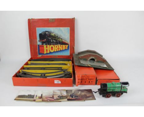 A group of Hornby related 0 gauge models, including boxed and vintage related railway postcards, a 0-4-0 clockwork locomotive