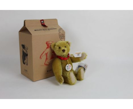 A Steiff limited edition Anniversary teddy bear, "100 Years of Steiff", having a blonde mohair covered body, wearing a red sa