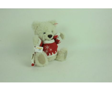 A Steiff Harrod's teddy bear, "Oscar 2008", having a cream alpaca fur covered body, wearing a red and white jumper with mitte