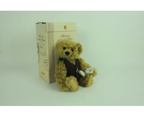 A Steiff Harrod's teddy bear, "Howard, a musical bear", having a brass blonde mohair covered body, wearing a tweed waistcoat,