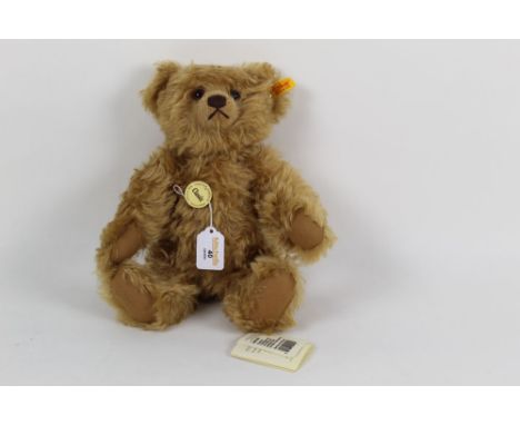 A Steiff Classic teddy bear, 004421, having circular chest tag, cinnamon brown coloured fur, fully jointed body, with working