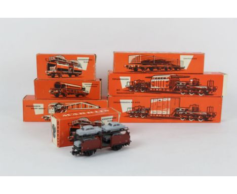 A group of 7 Marklin H0 scale wagons and rolling stock, to include a Tiefladewagan freight car, two auto transporters, and a 