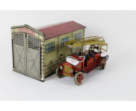 A German clockwork tin plate fire engine and fire station, by Johann Distler, with "JDN" trademark, the engine having three f