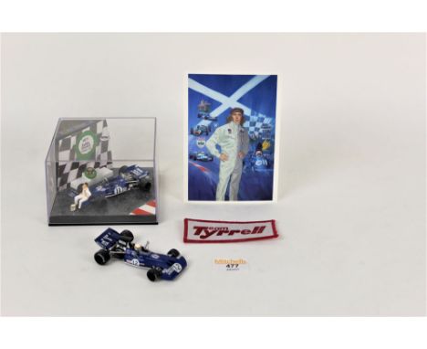 A Jackie Stewart Tyrell 003 special edition boxed car with certificate, a postcard, and original Tyrell sew-on patch, and one