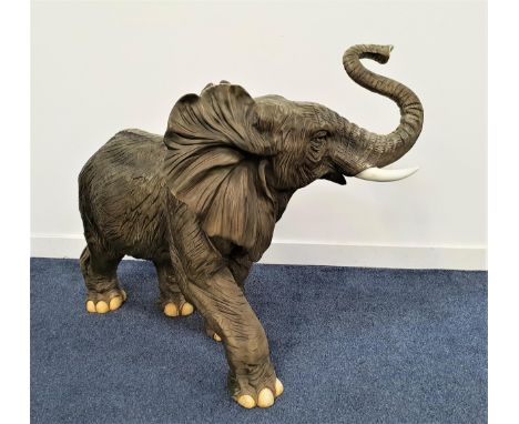 LARGE RESIN ELEPHANTwith his trunk raised and ears extended forward, 82cm high 