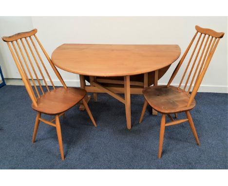 ERCOL MID CENTURY ELM 'WINDSOR' GATE LEG TABLE AND TWO 'WINDSOR GOLDSMITH' CHAIRSthe table model 610, the top 142cm (fully ex