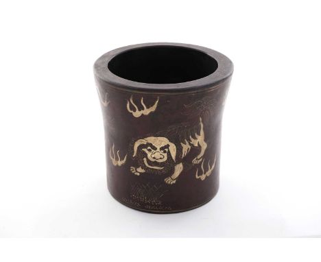 A Chinese lacquer on earthenware bitong, decorated in gilding with Buddhist lions and brocade balls on a dark brown ground, f