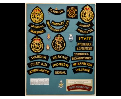 Civil Defence and ARP Insignia A card displaying four gilt and enamel lapel-badges and 23 shoulder-titles or arm-badges, in y