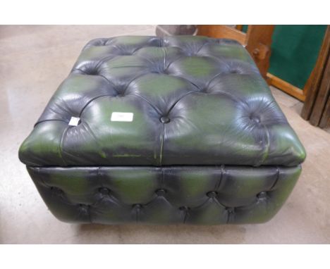 A green leather buttoned pouffe