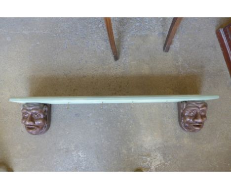 A gargoyle shelf/coat rack