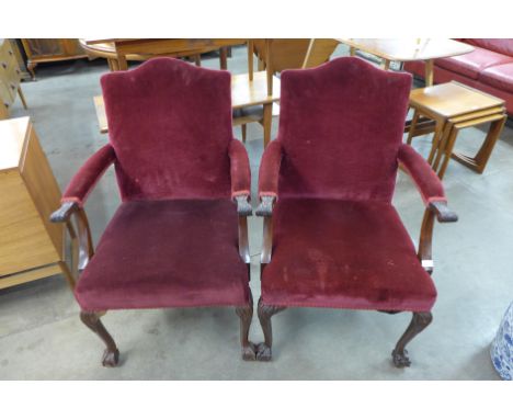 A pair of early 20th Century Chippendale Revival carved mahogany and upholstered open armchairs