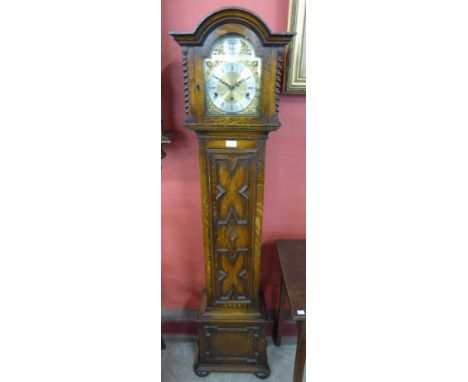 An oak geometric moulded dwarf longcase clock