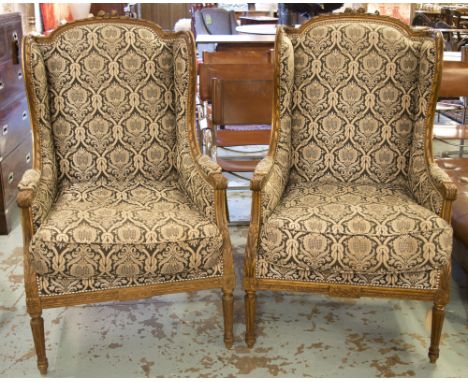 BERGÈRES À OREILLES, a pair, early 20th century beechwood, with tapestry design upholstery (labelled Fabrique de sieges, Gabr