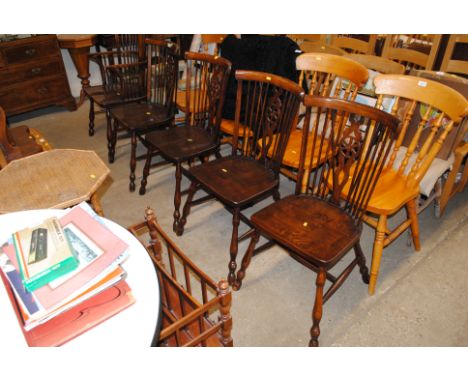 A set of four elm seated stick and wheelback dining chairs