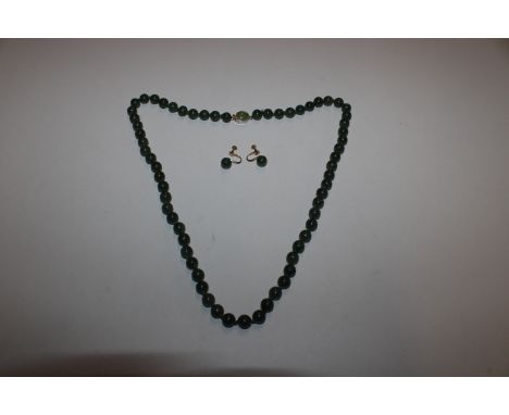 A string of jade beads and pair of matching jade earrings with 925 silver gilt fittings 