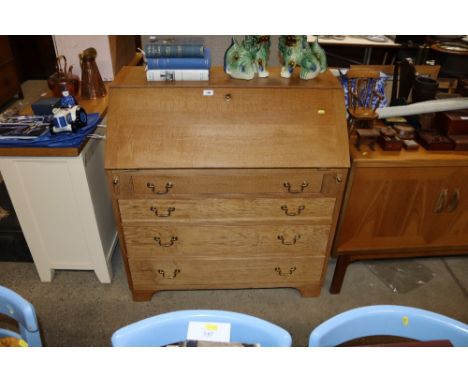 A light oak and plywood bureau fitted four drawers 