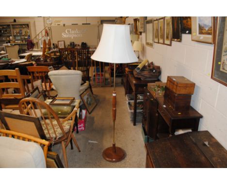 A teak standard lamp and shade
