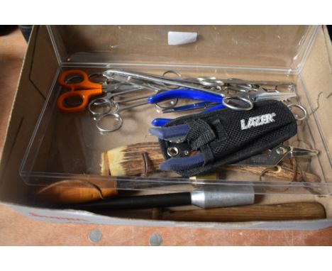 Four fishing priests and some tools including forceps crimpers , scissors and multi tool in a Brady canvas bag