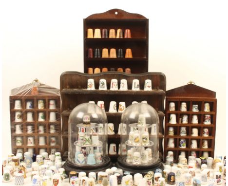 A large collection of modern ceramic thimbles, including some on display shelves and stands, including; Caverswall, Sutherlan