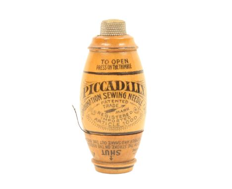 An unusual barrel form "Piccadilly Combination Sewing Needle Case", transfer decorated with trade mark, contents list, etc., 