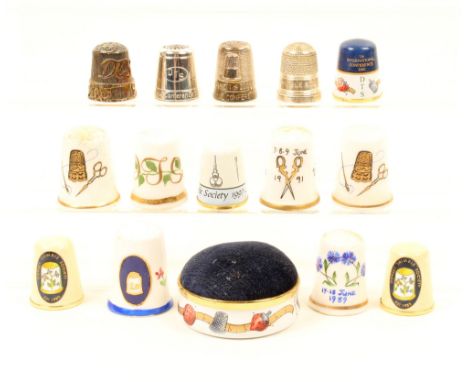 Fourteen thimbles and a pincushion relating to The Dorset Thimble Society, comprising; thimbles in enamel 1997, 1999 (x2), on