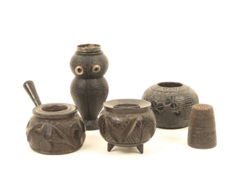 Four carved Irish bog oak thimble stands, including one with bog oak thimble, comprising; a bun form example carved with harp