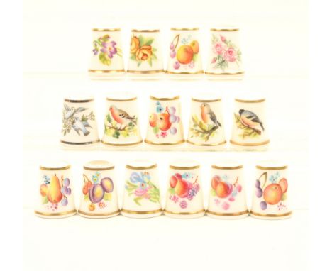 Fifteen black mark Royal Worcester thimbles, twelve painted with fruit or flowers, three of birds, all signed. (15)