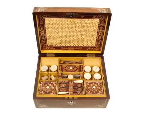 A mid-Victorian rosewood rectangular sewing box, the lid and front with pewter lines and cut mother of pearl floral decoratio