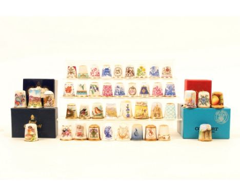 Forty two ceramic thimbles, comprising; seventeen hand painted by various artists and of various subjects, nineteen transfer 