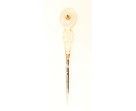 A good mother of pearl Palais Royal mounted steel stiletto, the carved handle with circular gilt and enamel pansy motif, gilt