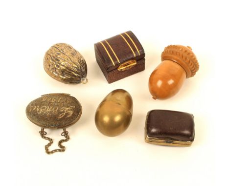 Six thimble cases, comprising; a brass floral decorated egg form example on chain, inscribed "Londre 1908", 4.8cm, a plain br