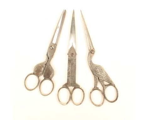 Three pairs of larger format steel scissors, comprising; a clock tower pair, 16cm, a stork form pair, 16.5cm, and a portrait 