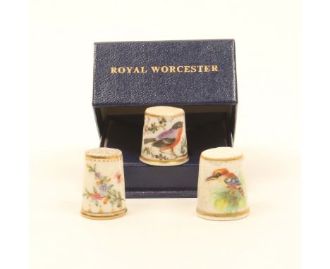 Three English porcelain thimbles, comprising; a 19th century example painted with a bird within flowering branches, within gi