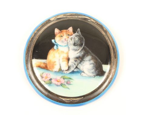 An early 20th century continental white metal and enamel decorated lady's compact of circular form, the hinged lid with two c