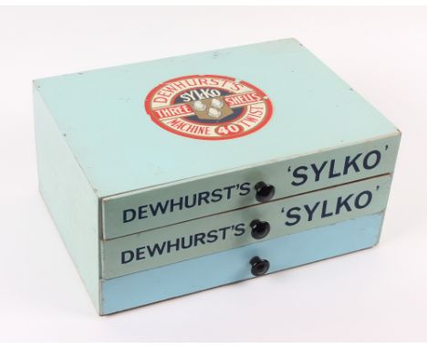 A counter advertising chest of three drawers, the top with reel end for "Dewhurst's - Three Shells - Sylko Machine Twist", tw
